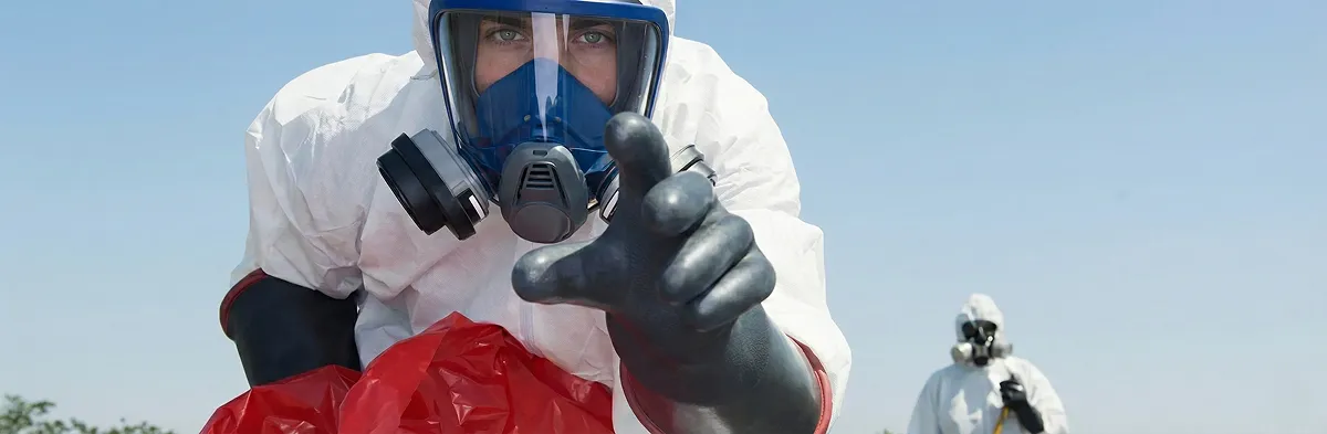 sewage clean up technician wearing protective gear handling biohazard materials in Detroit, MI