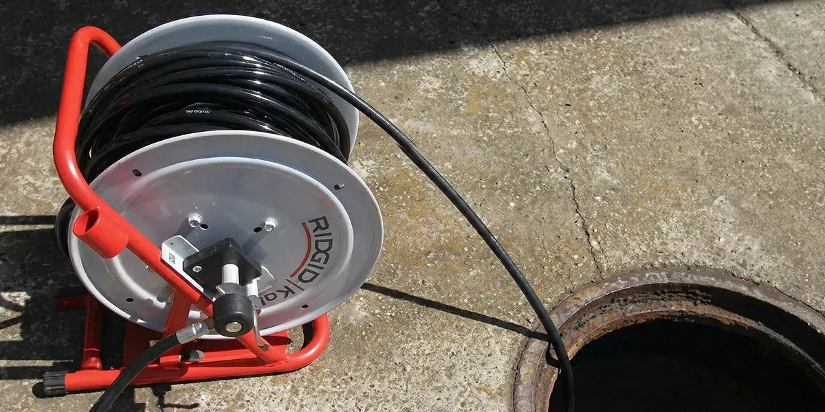 sewer rodding equipment prepared to clear clogged sewer lines in Detroit, MI